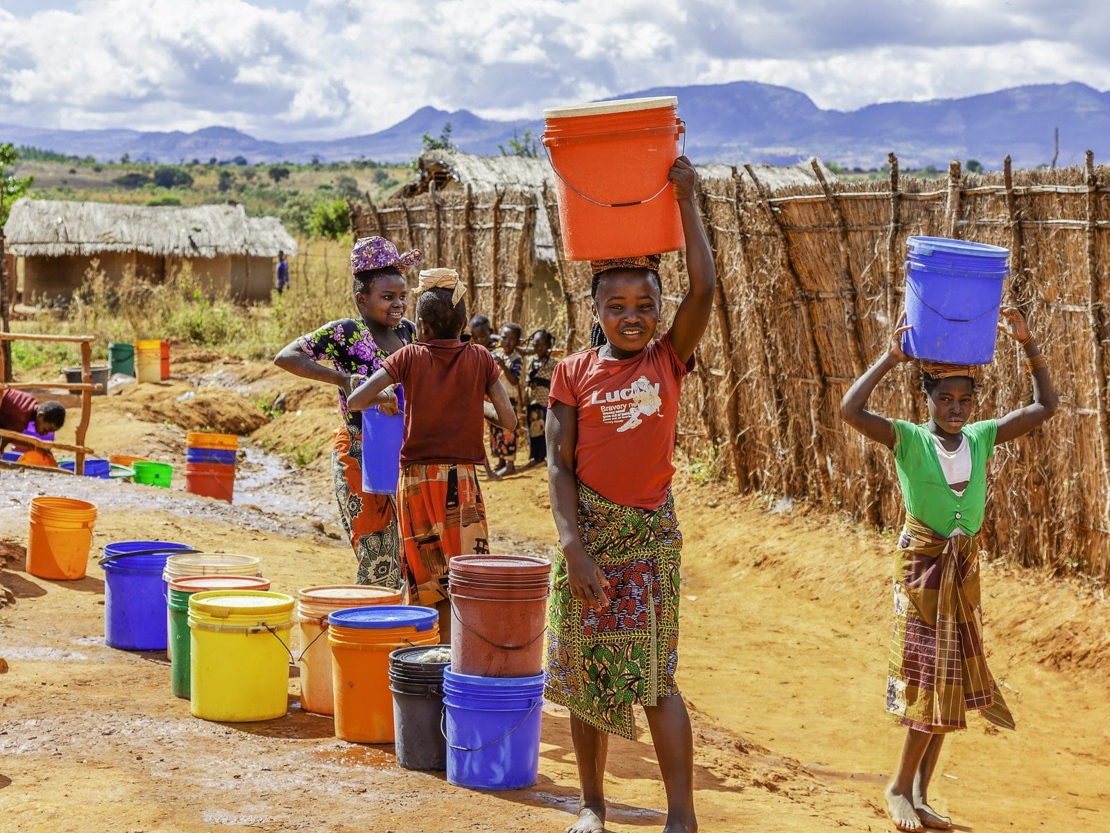 Village children collecting water from the local borehole in Mozambique.