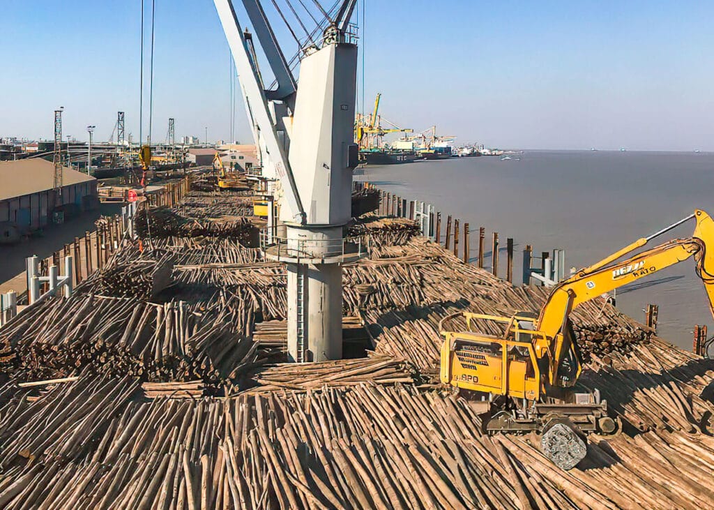 Moz Fibra pulpwood logs being loaded onto a ship for export at Beira Port Mozambique